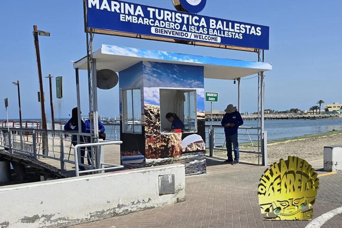 a man standing next to a kiosk on a pier