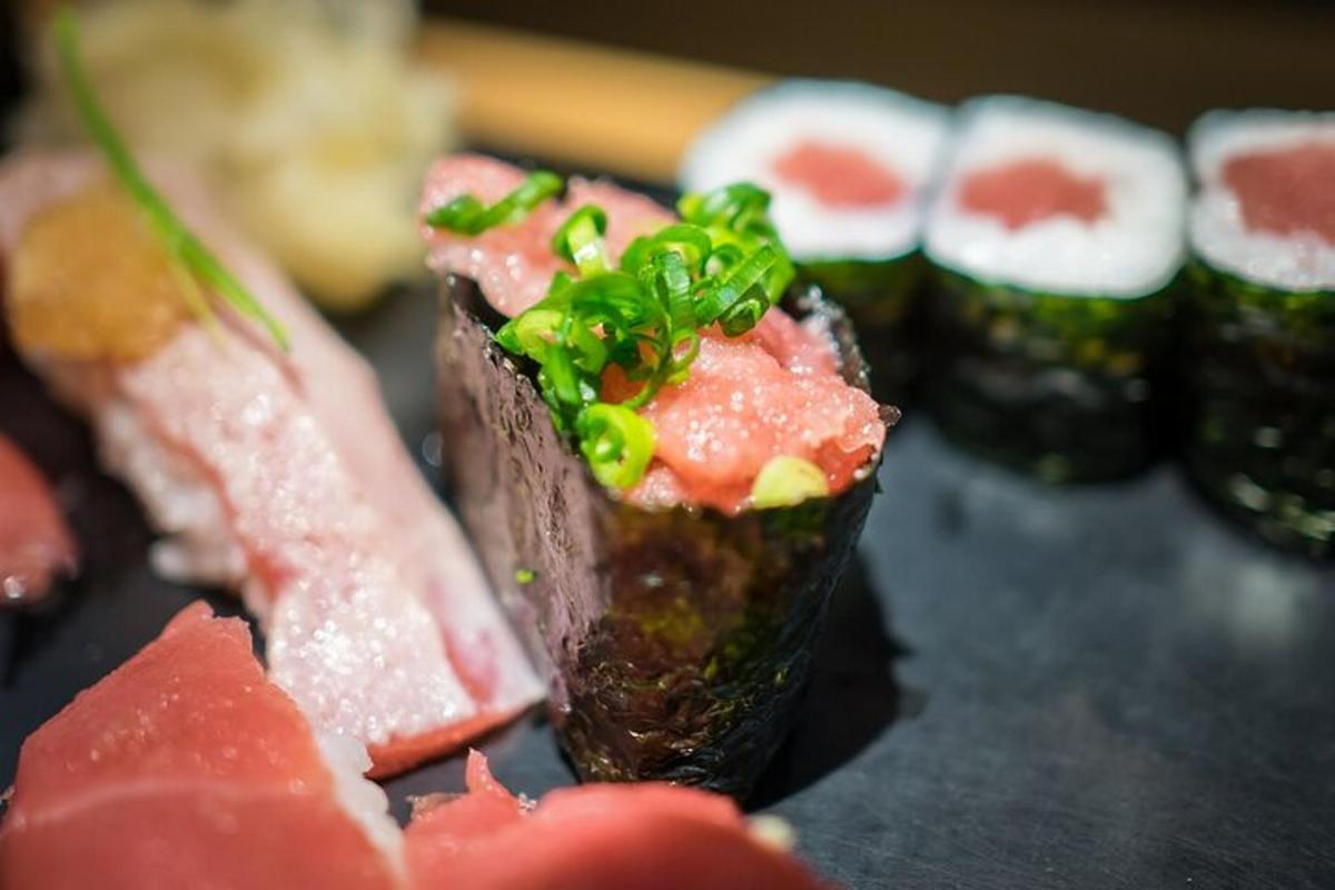 a plate of food with sushi on a table