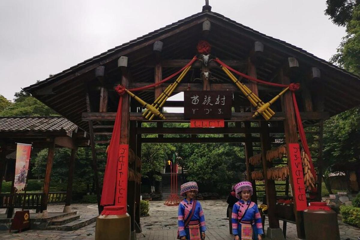 two children are standing in front of a gate