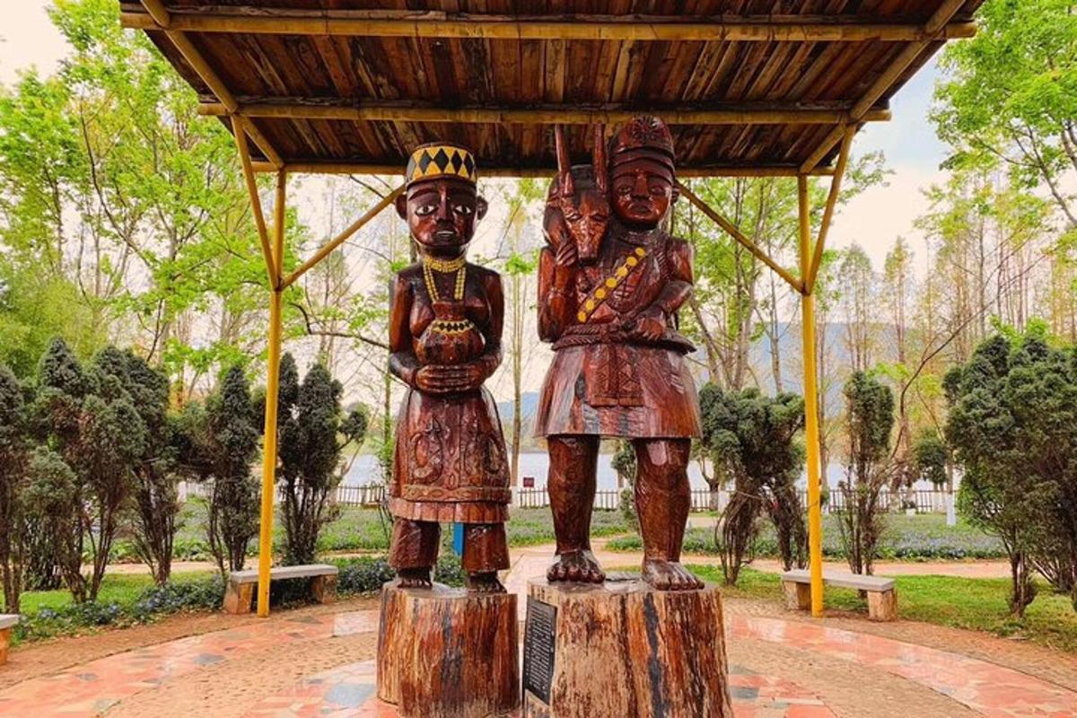 a statue of three people standing on logs