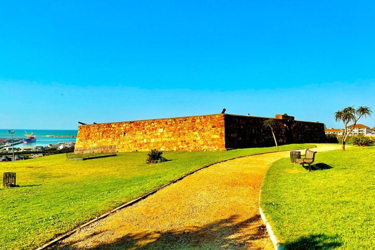 a brick building sitting on top of a lush green field