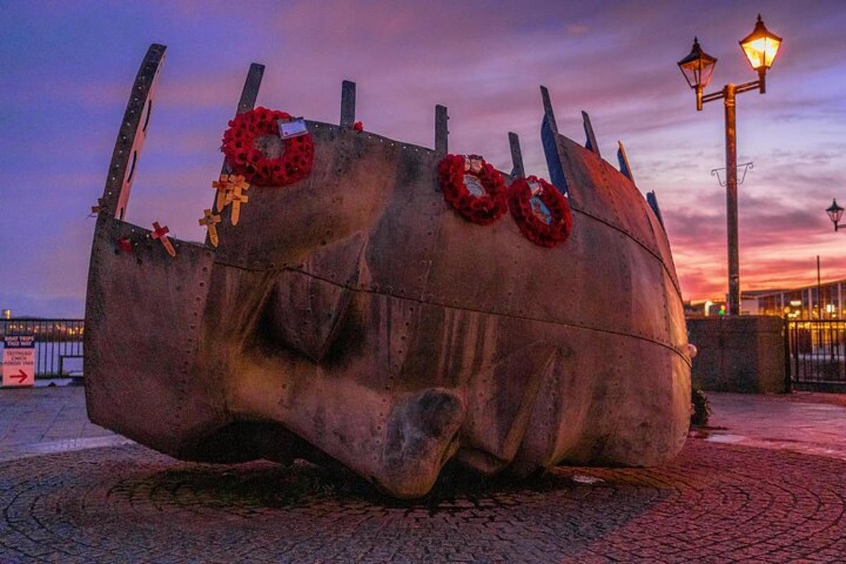 a statue of a cow with red wreaths on it