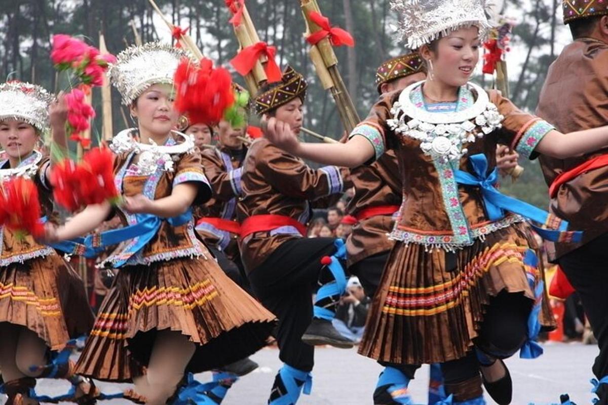 a group of children in traditional costumes dancing in a parade
