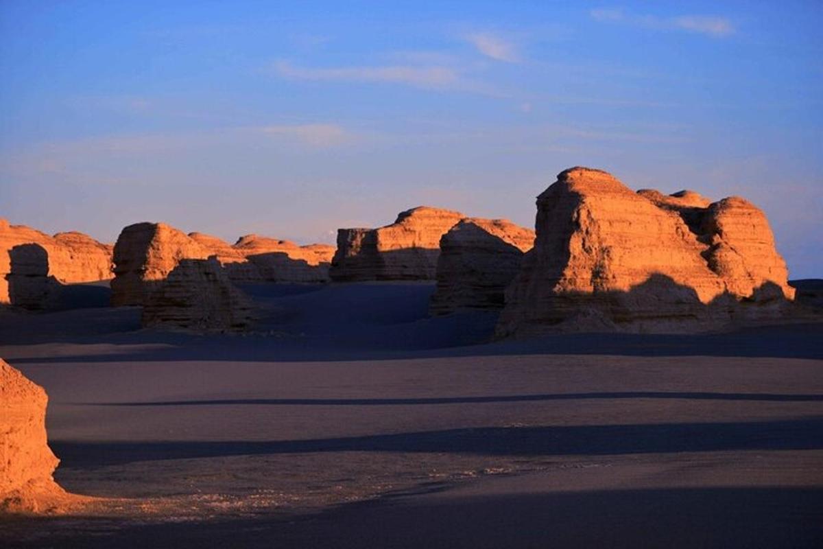 a view of a desert with rock formations