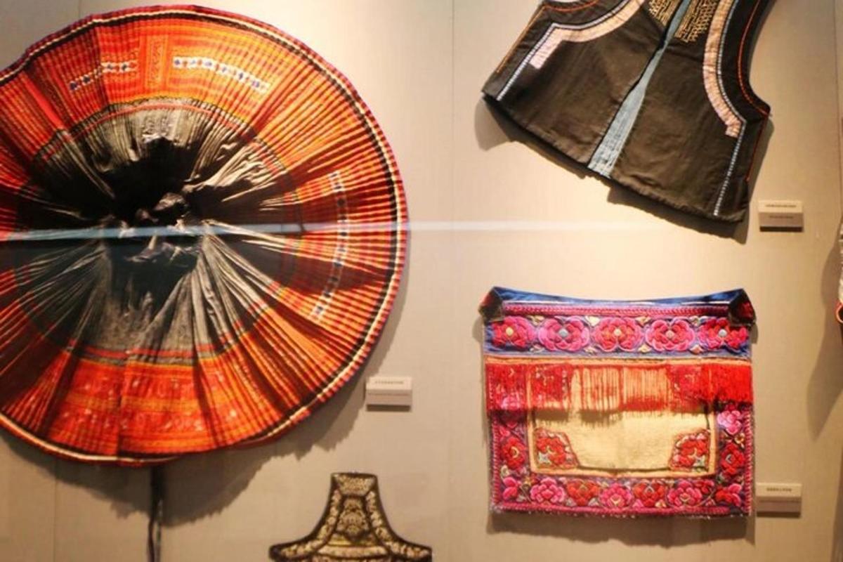 a display of oriental hats and mats on a wall