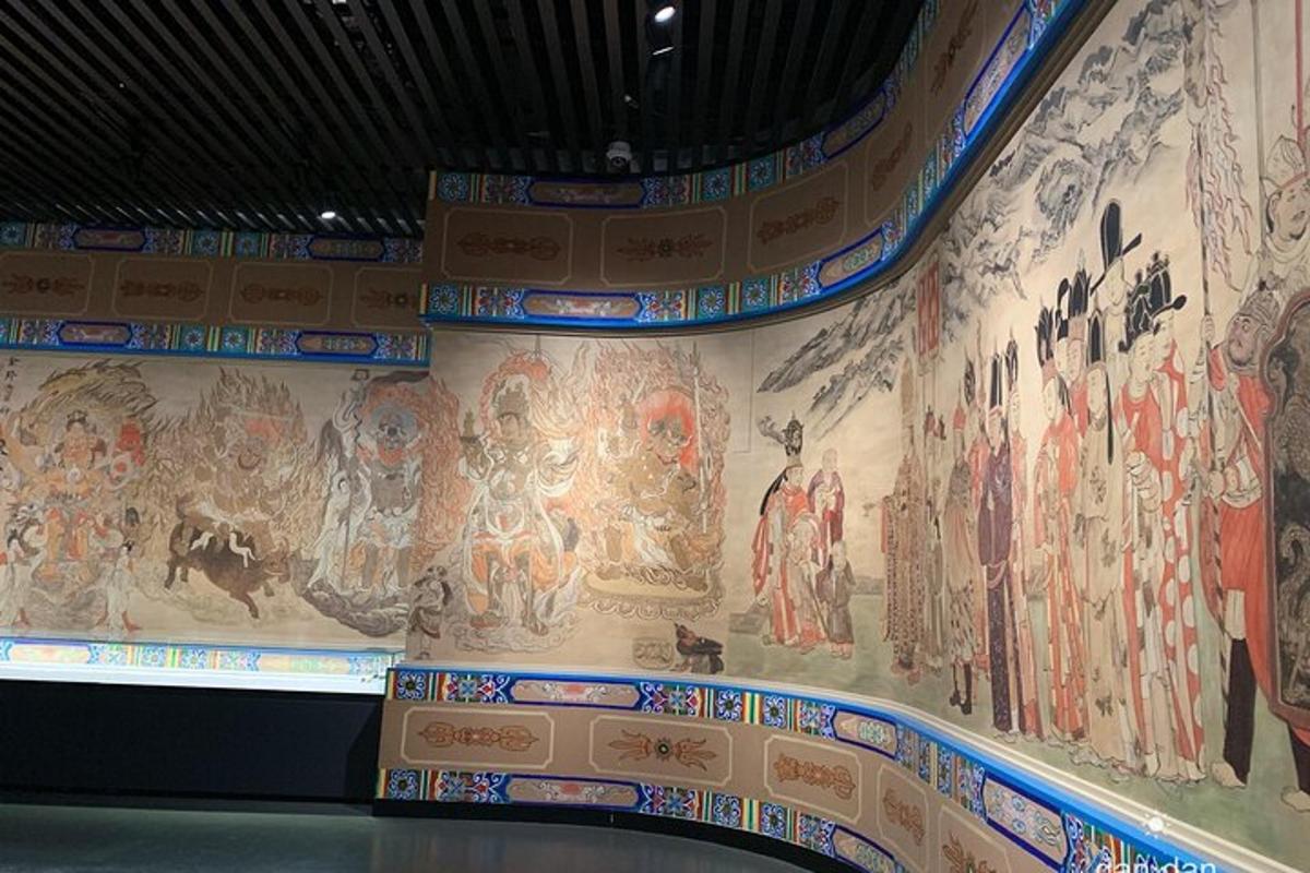 a wall in a temple with paintings on it
