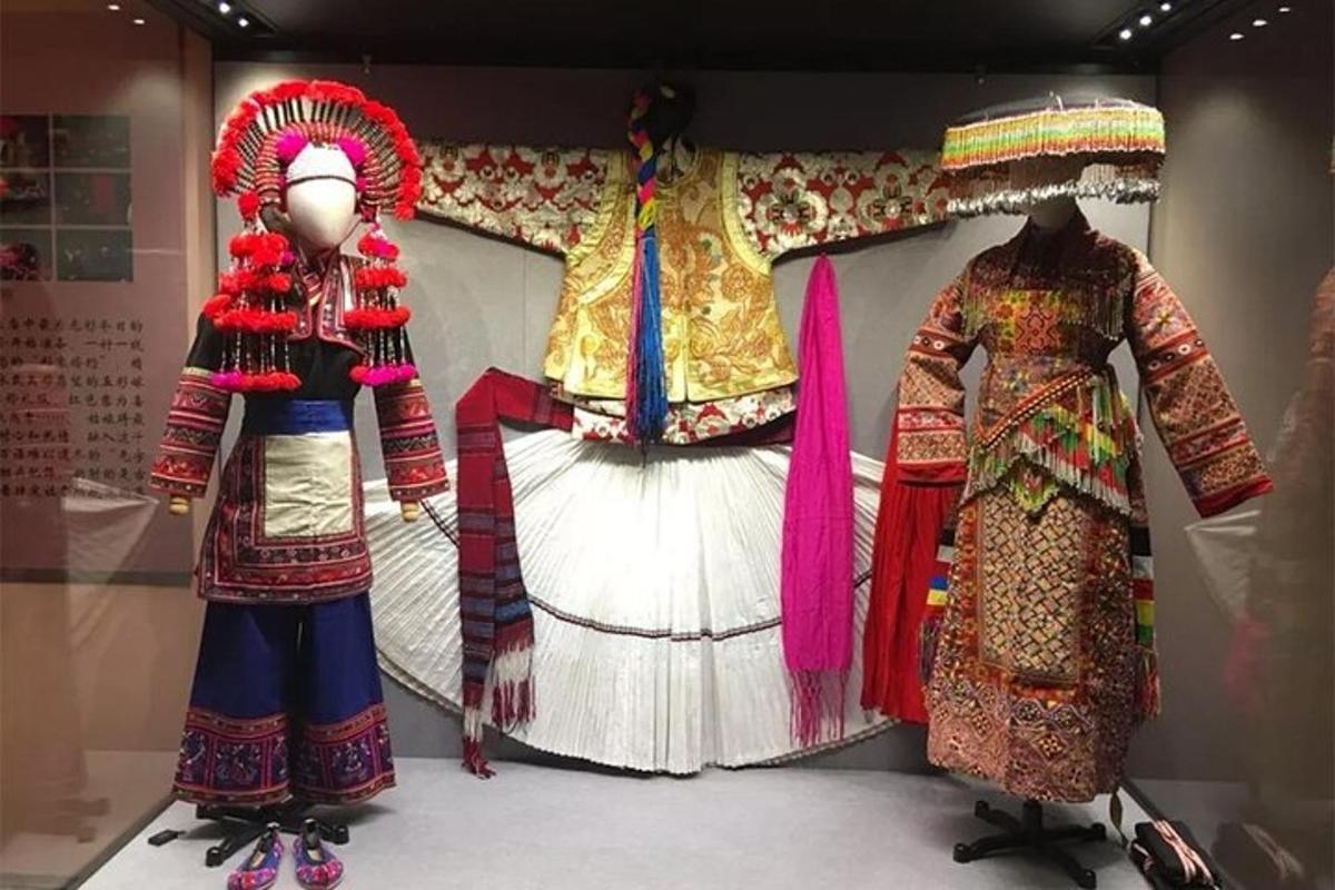 two dresses in a display case in a museum