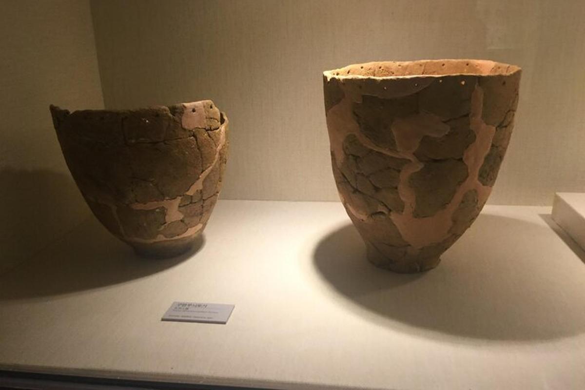 two vases sitting on a table in a museum