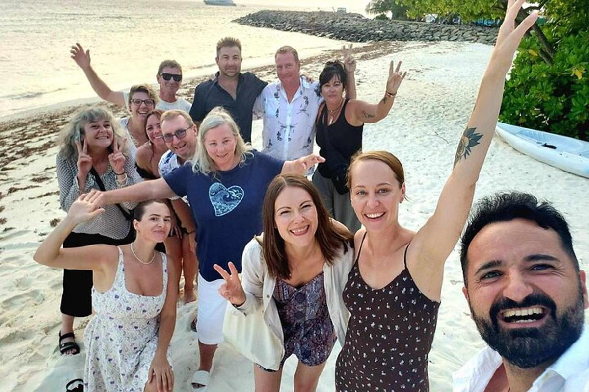 a group of people posing for a picture on the beach