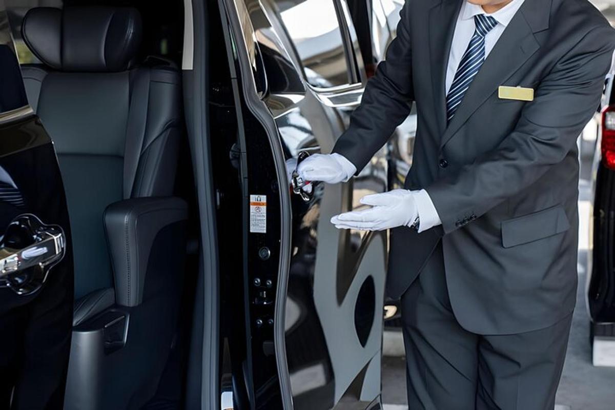 a man in a suit getting out of a car