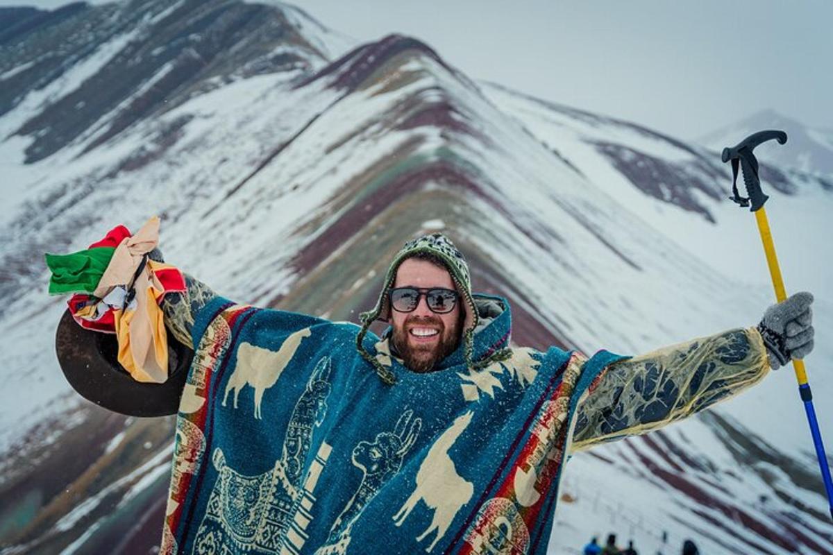 Un hombre está parado frente a una montaña