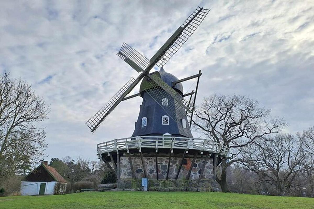 a large blue windmill sitting on top of a field