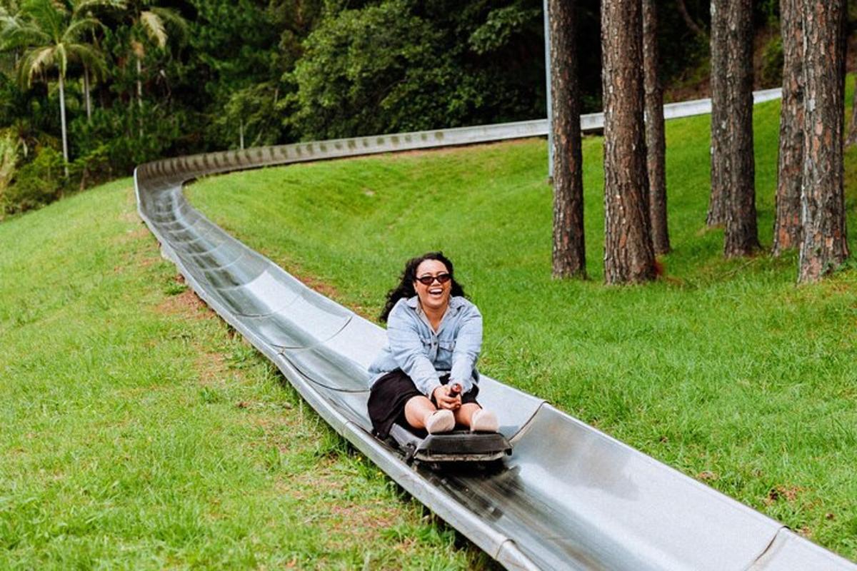 isang babae na nakaupo sa isang slide sa isang parke