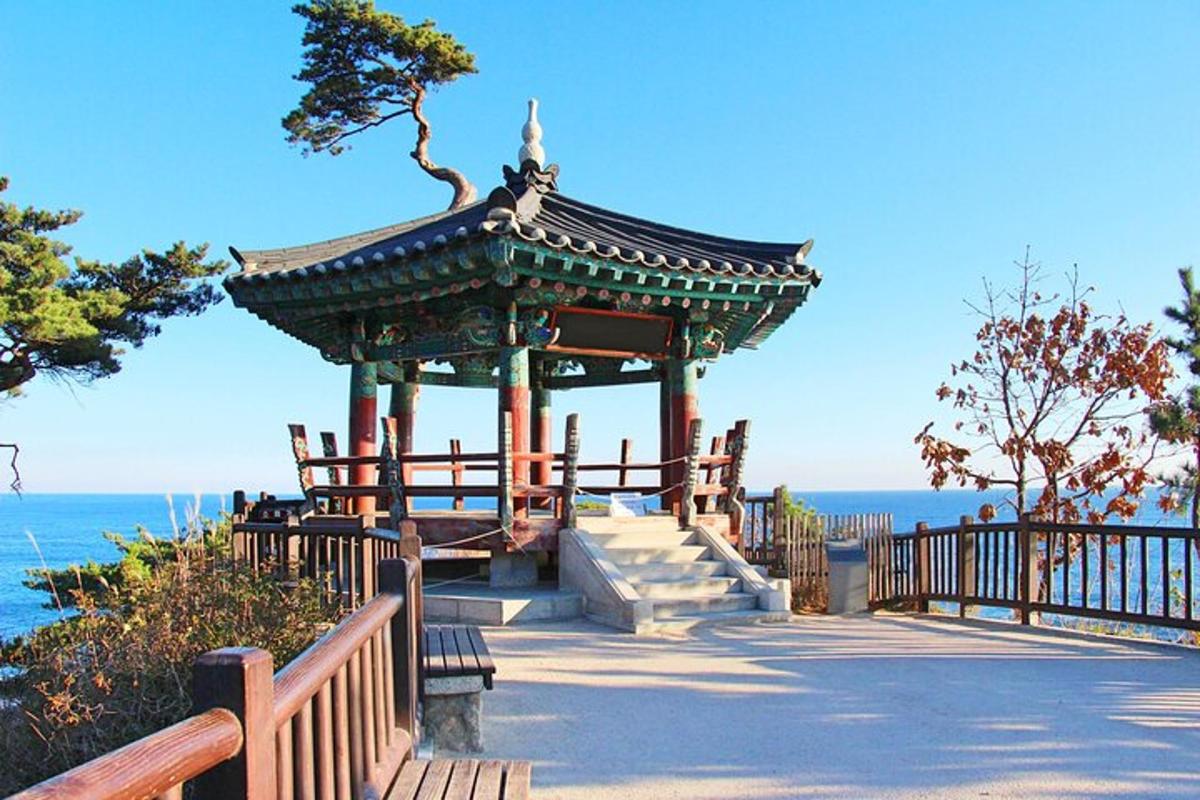 a gazebo on the beach next to the ocean