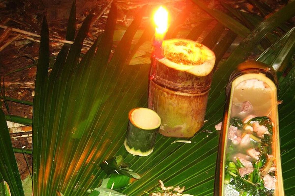 a candle sitting on top of a table with plants