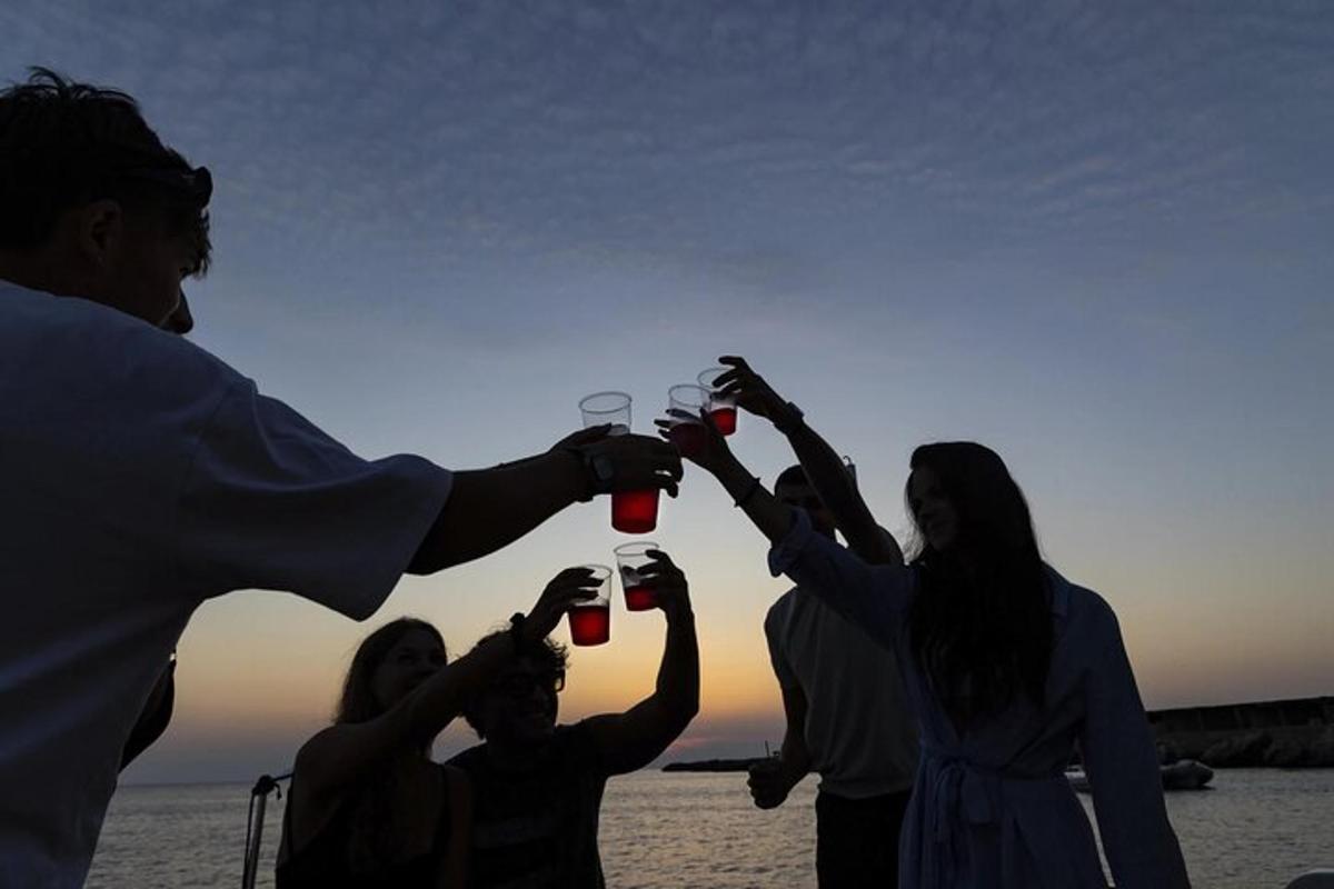 a group of people holding up wine glasses