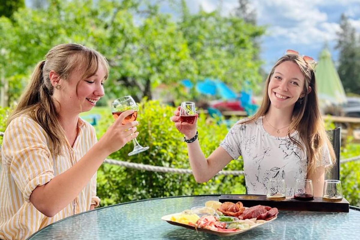 two women sitting at a table drinking wine