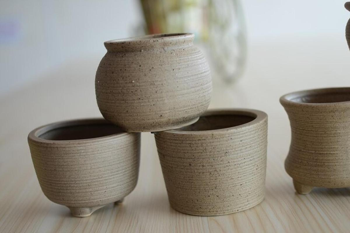 a group of four brown vases sitting on a table