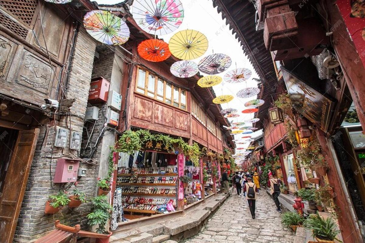 an alley with umbrellas hanging from the ceilings of a store