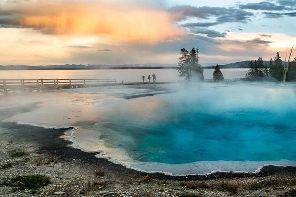people standing on the edge of a body of water