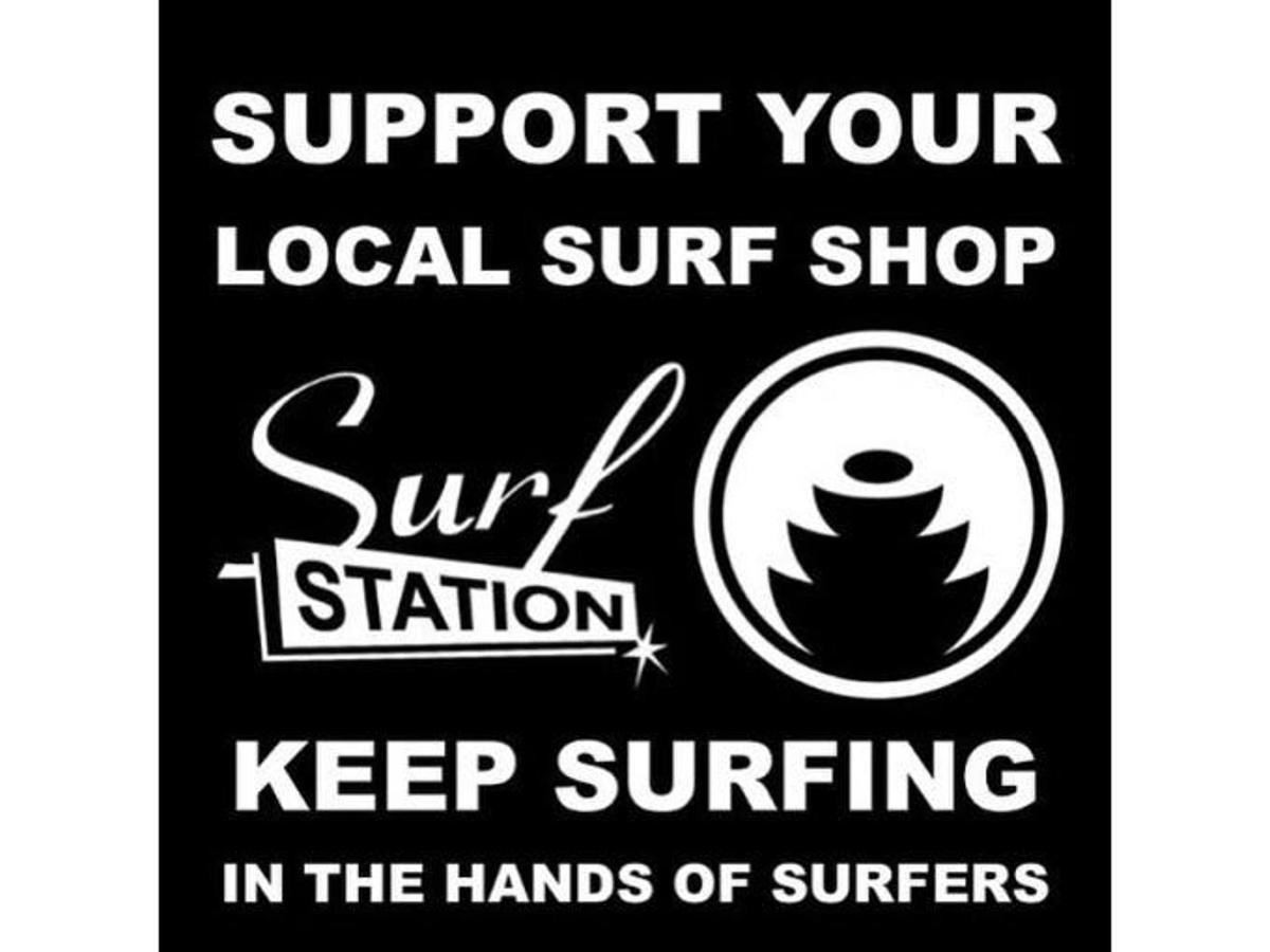 a sign that says support your local surf shop and keep surfing
