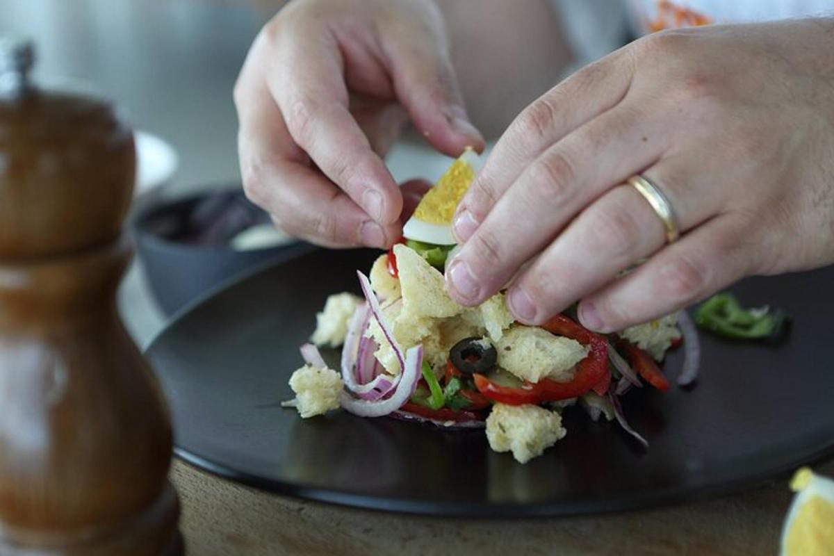 a person making a sandwich on a black plate