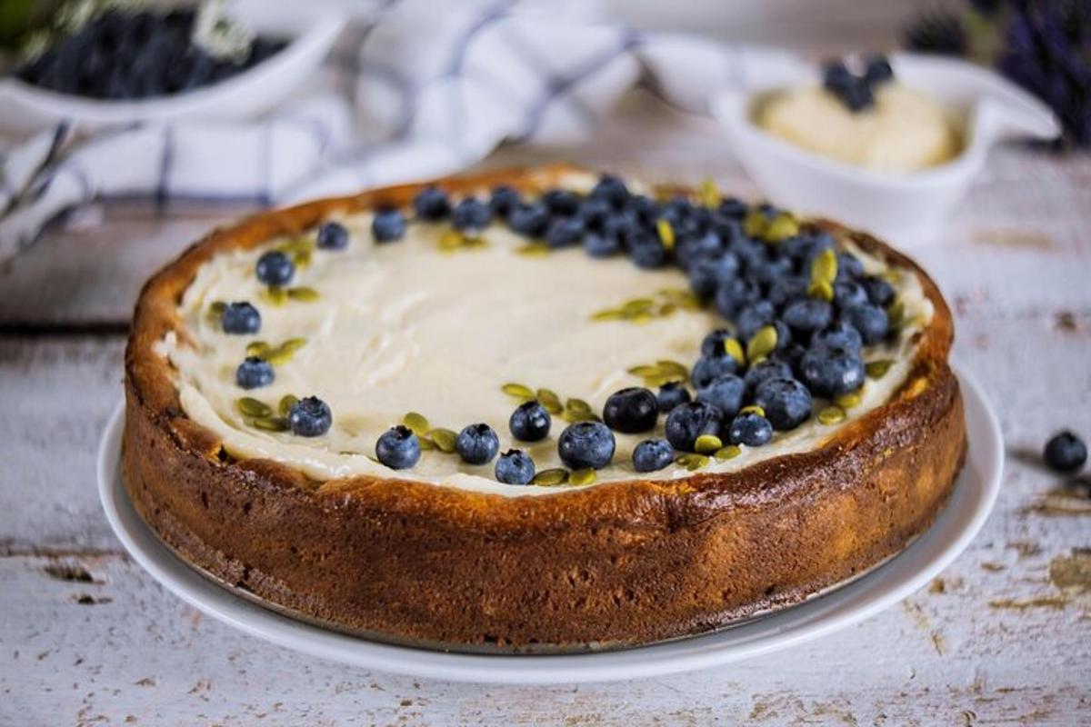 a cake with blueberries on a plate on a table