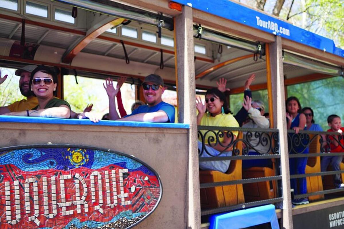 a group of people riding on a trolley