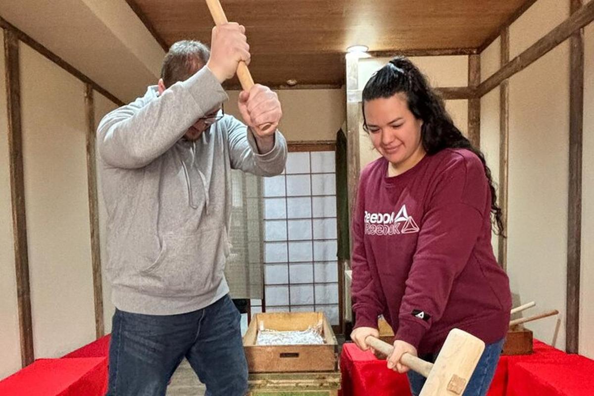 a man and a woman playing with wooden axes