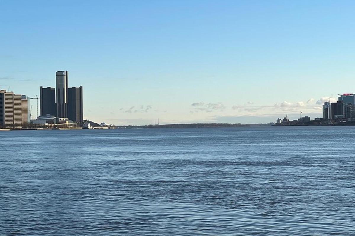 a large body of water with a city in the background