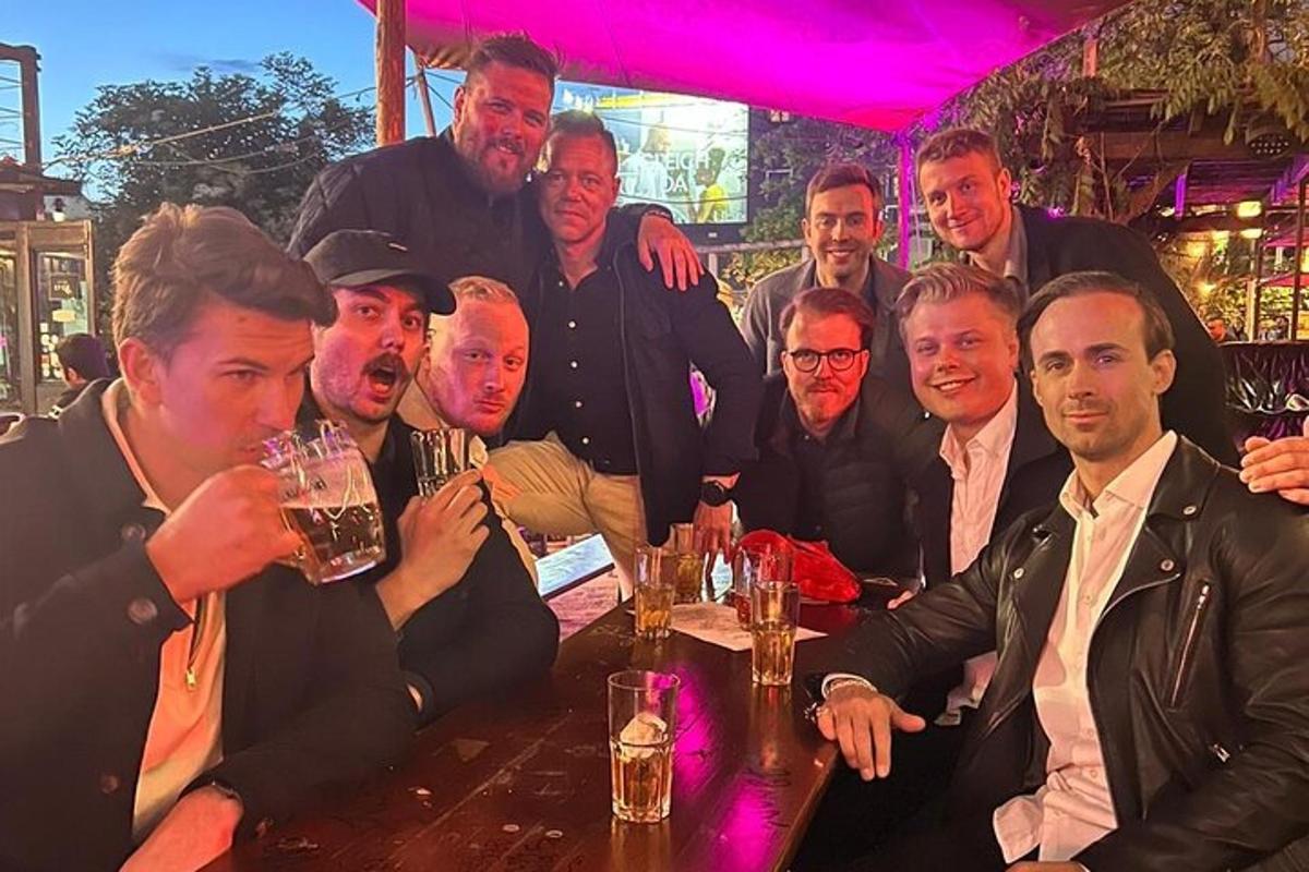 a group of men sitting at a table with drinks