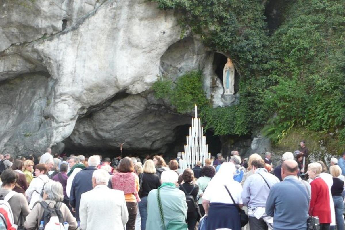 a large crowd of people standing in front of a cave