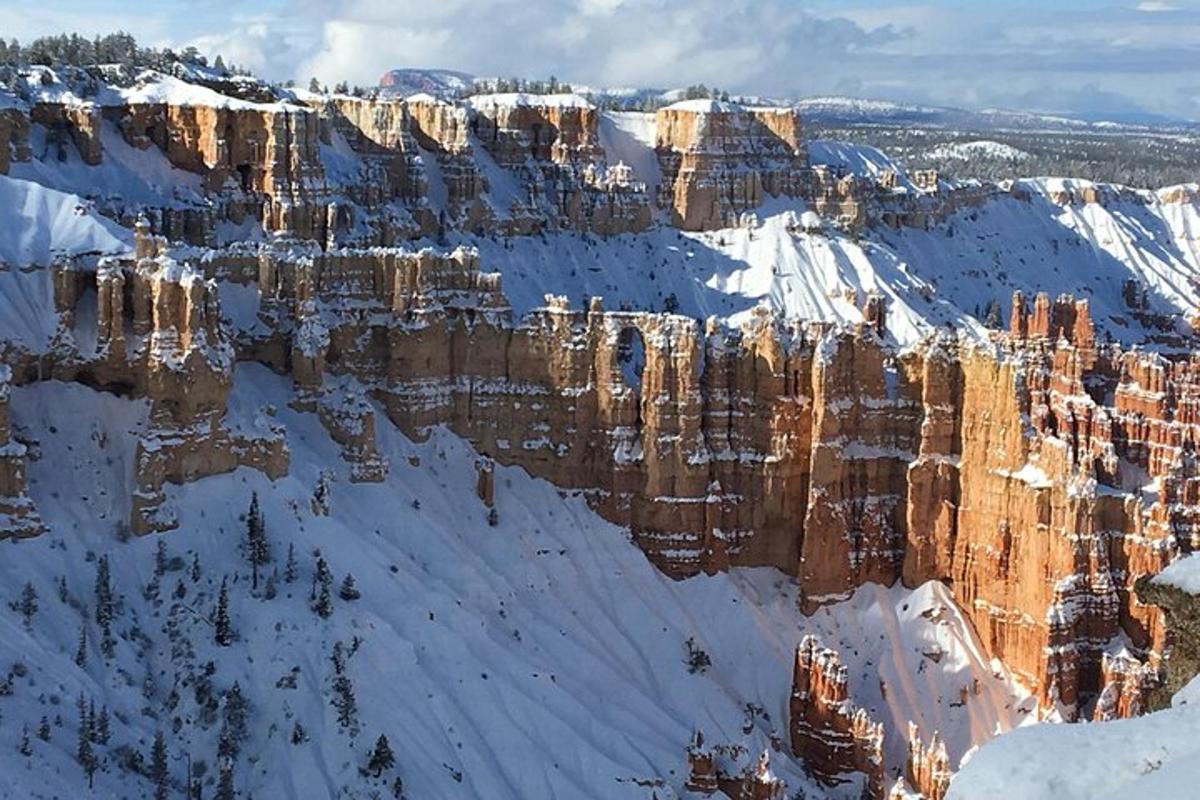 a view of a snow covered mountain with rocks