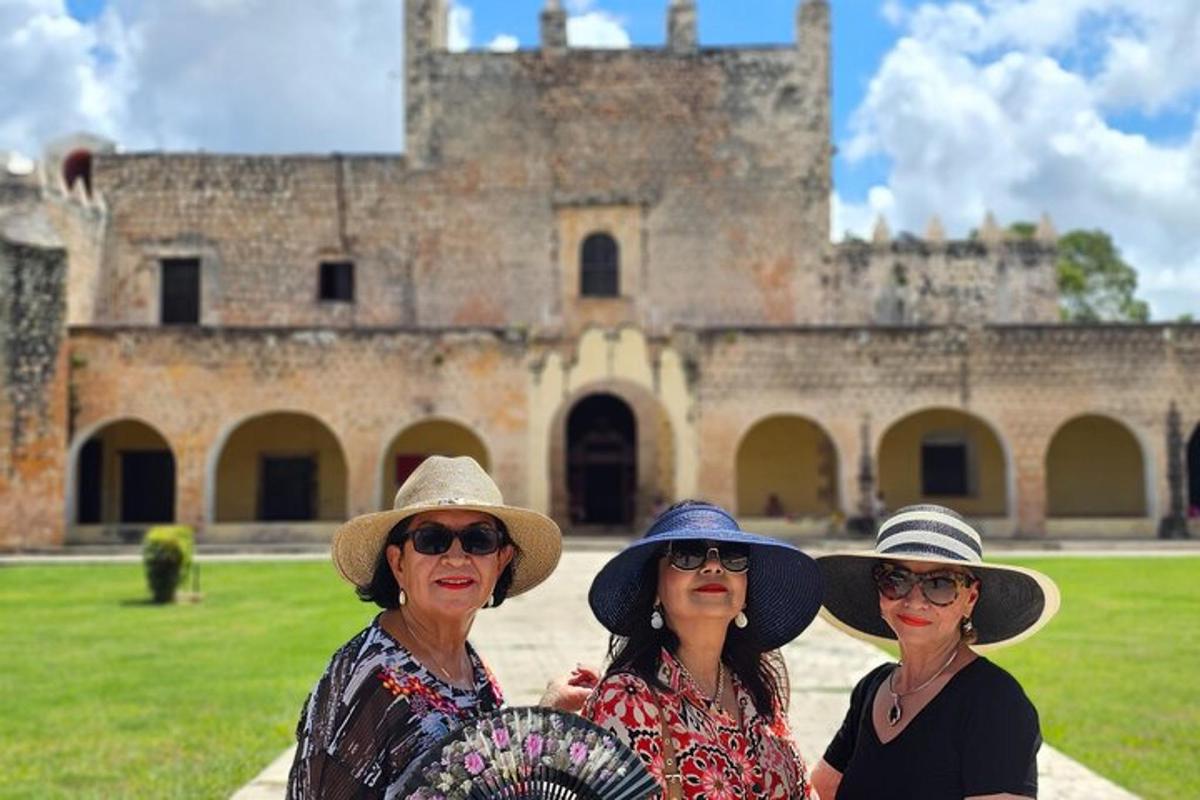 three women wearing hats standing in front of a castle