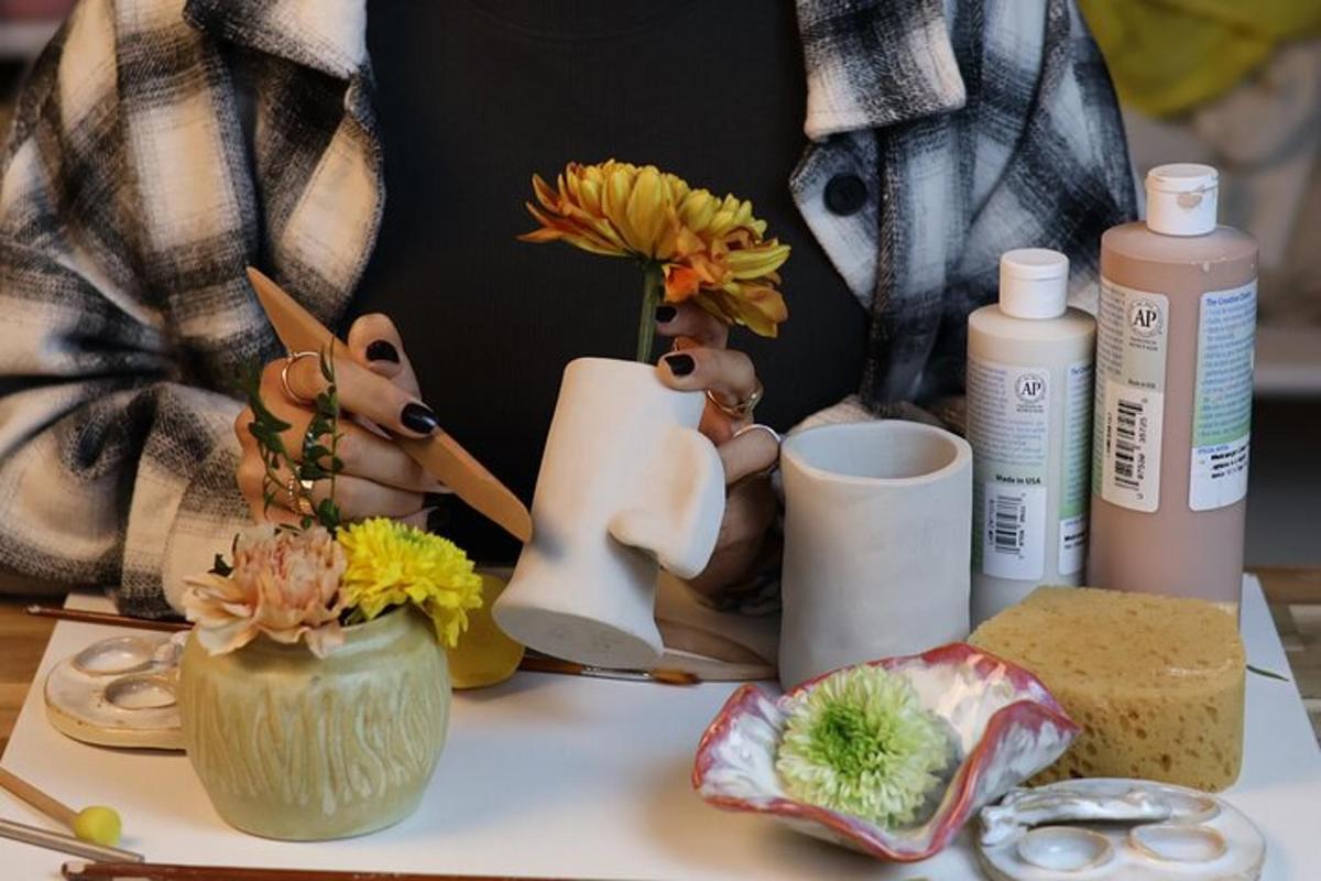 a table topped with vases with flowers and other items