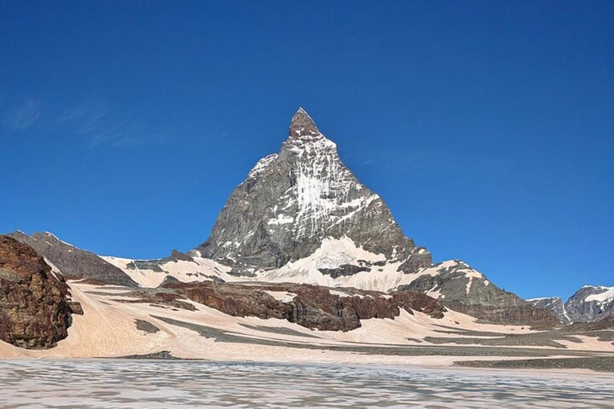 a mountain in the middle of a desert with water
