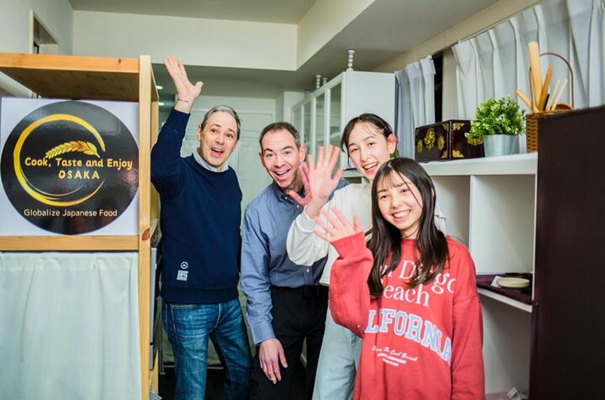 a group of people standing in a room with their hands up