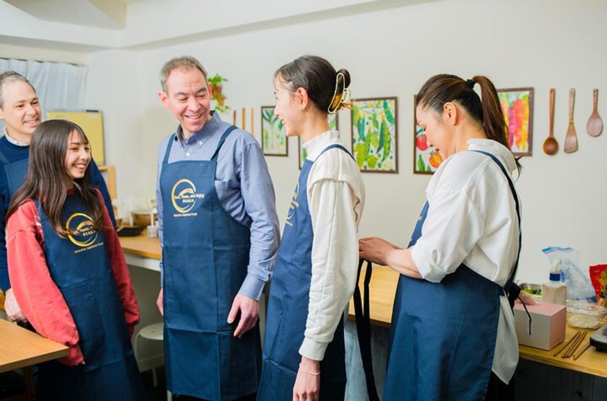 a group of people standing in a kitchen