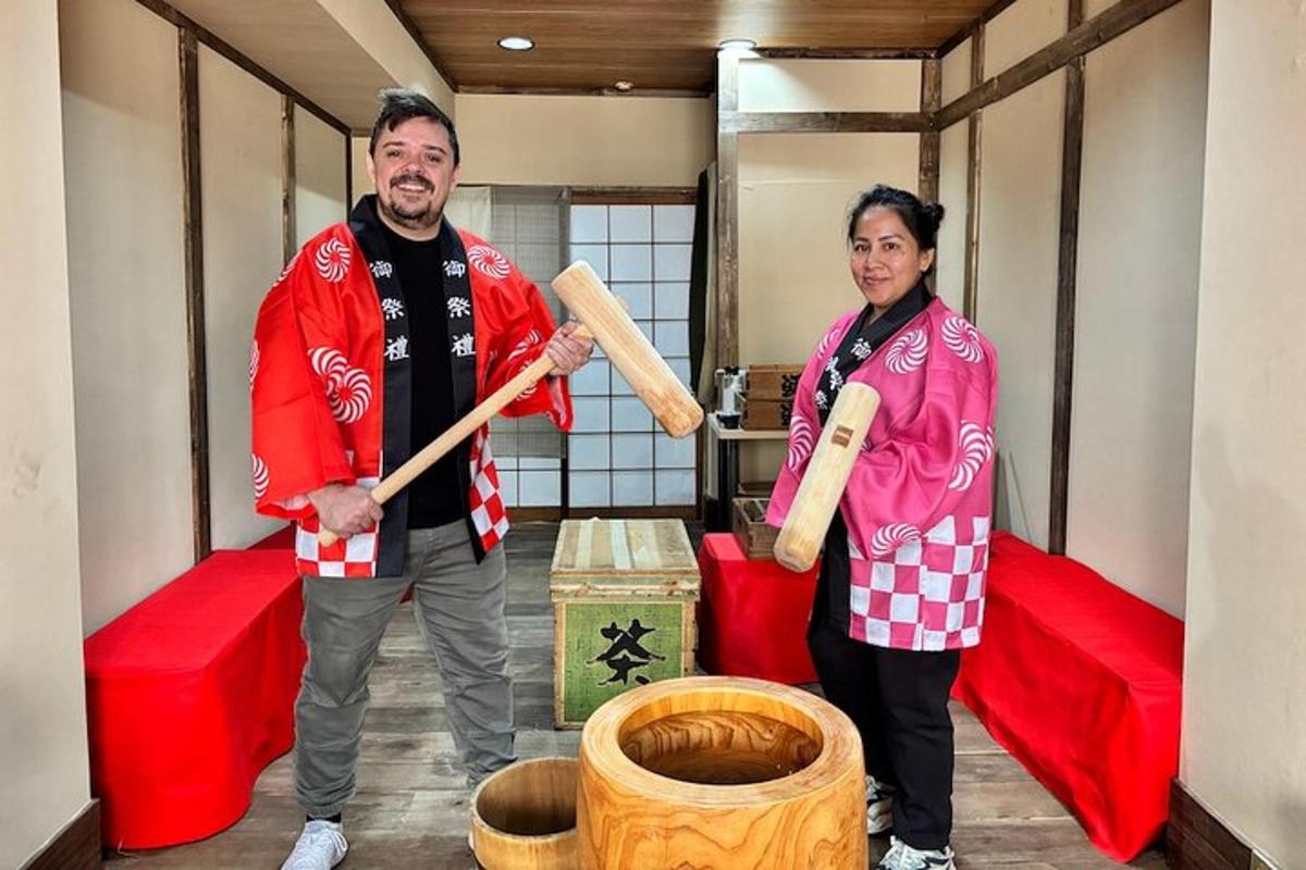 a man and woman standing in a room with baseball bats