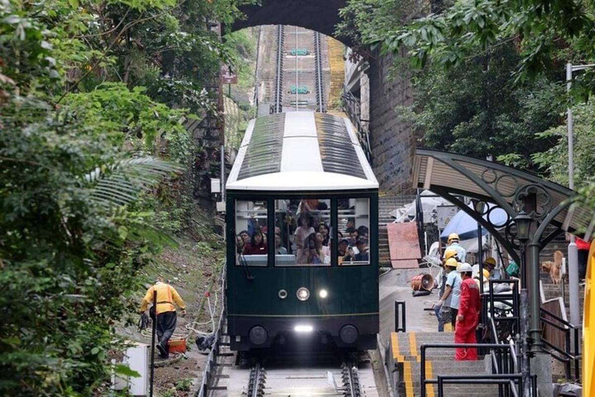 a trolley train pulling into a station with people