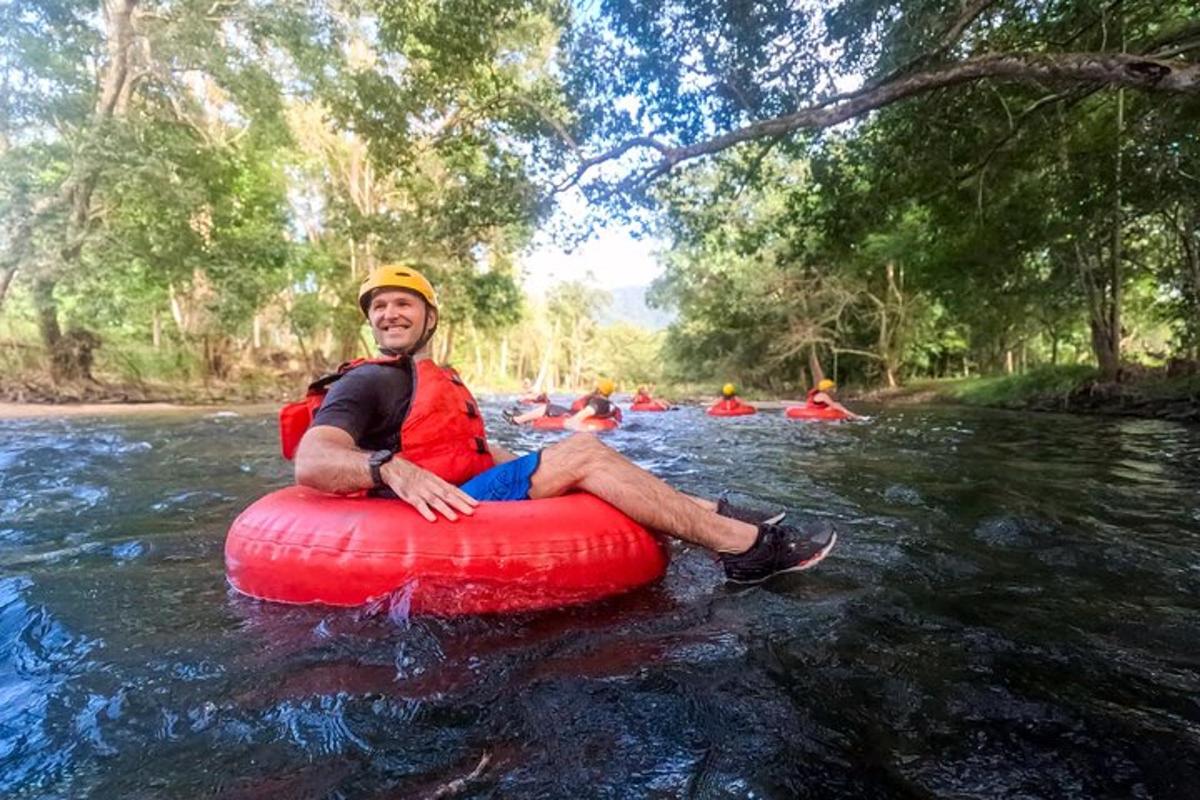 a man is sitting on a raft in a river