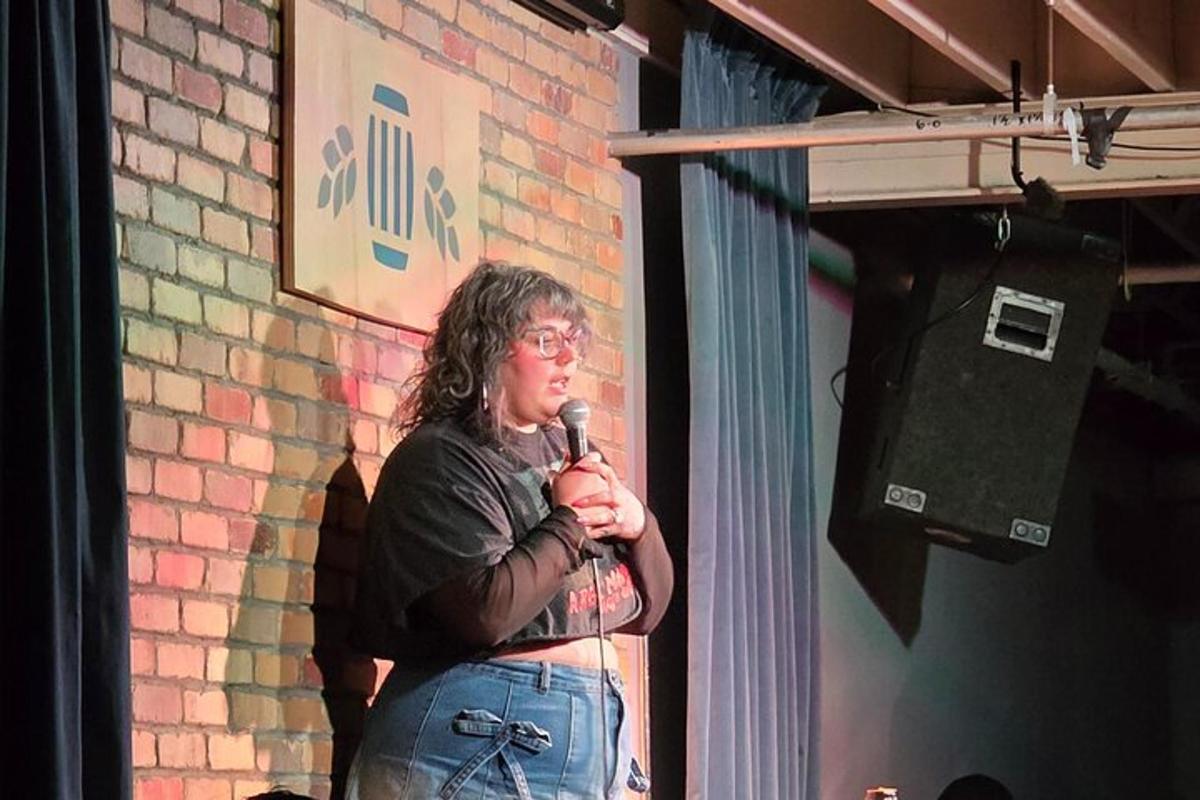 a woman standing on a stage holding a microphone