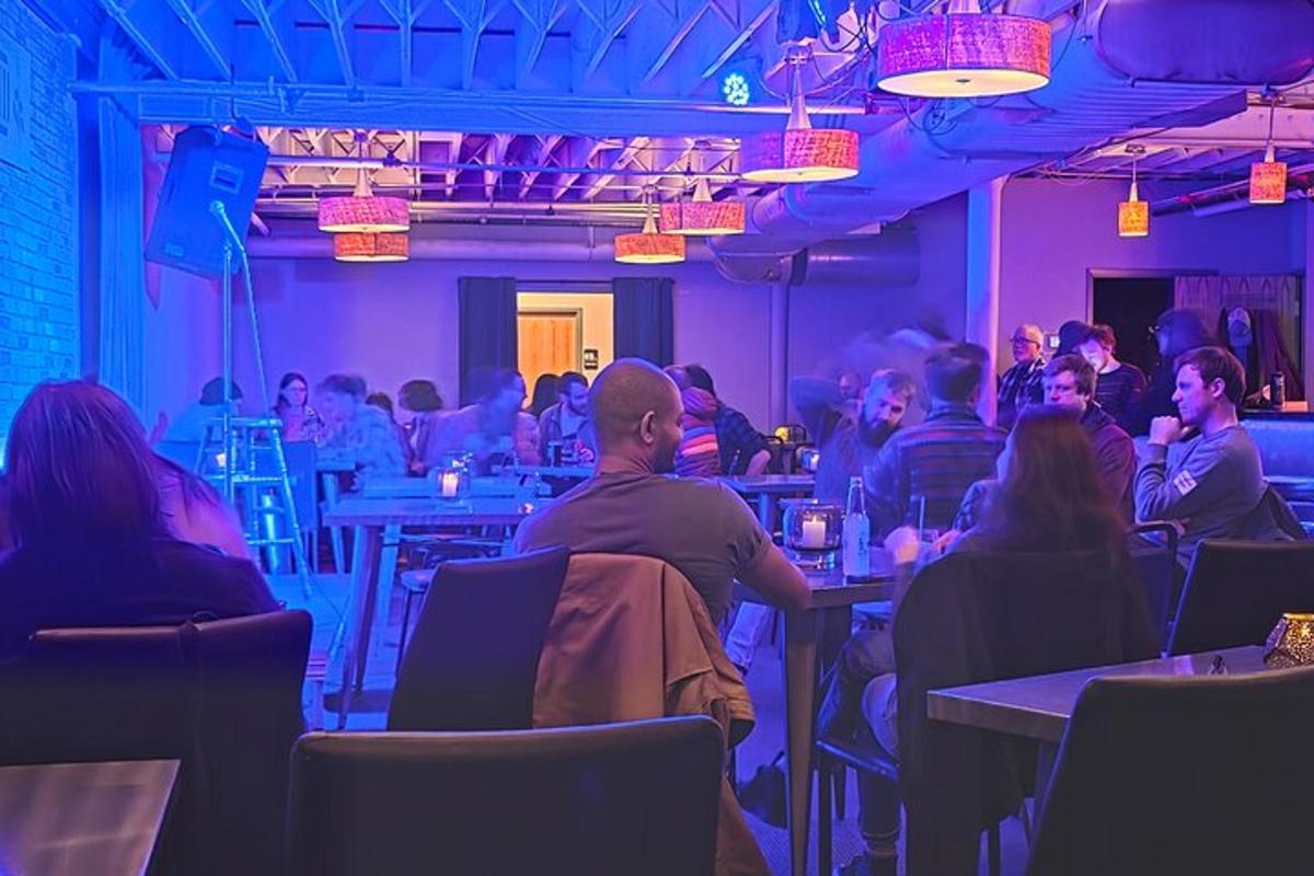 a group of people sitting at tables in a restaurant