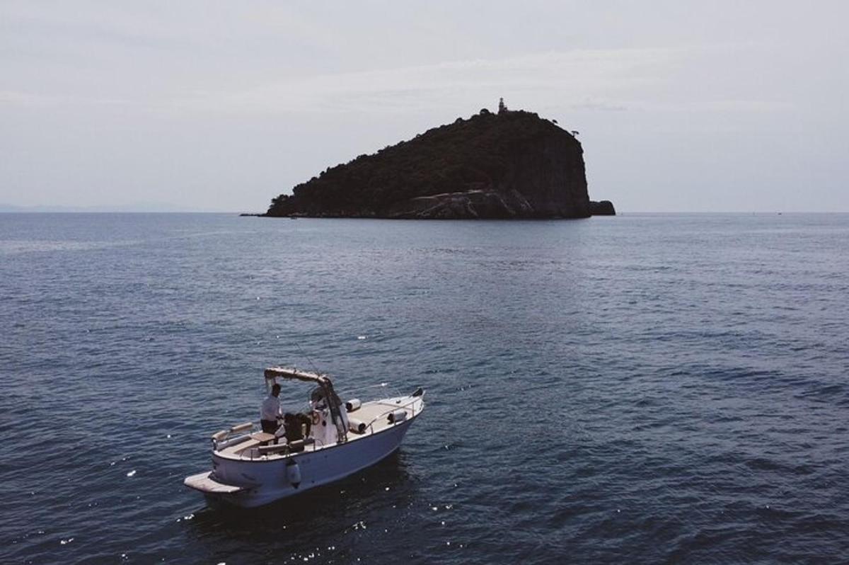 a boat in the water with an island in the distance