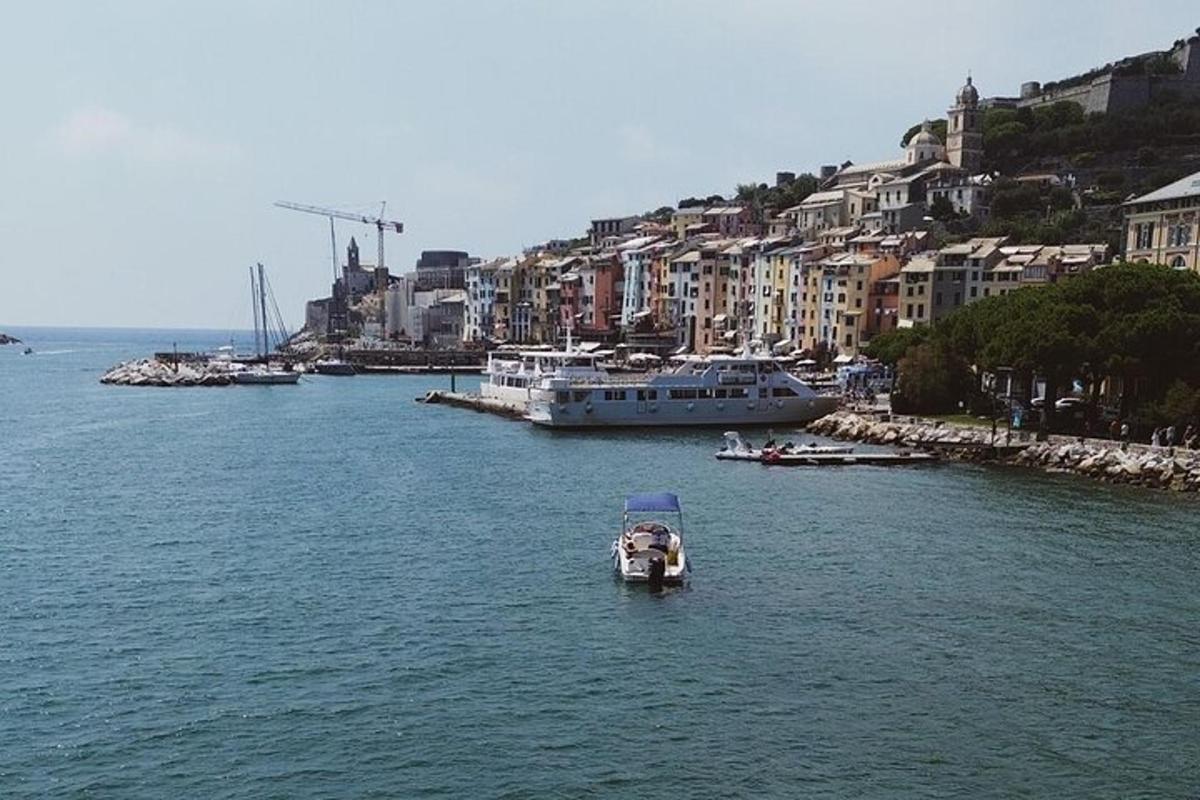 a small boat in a large body of water with buildings