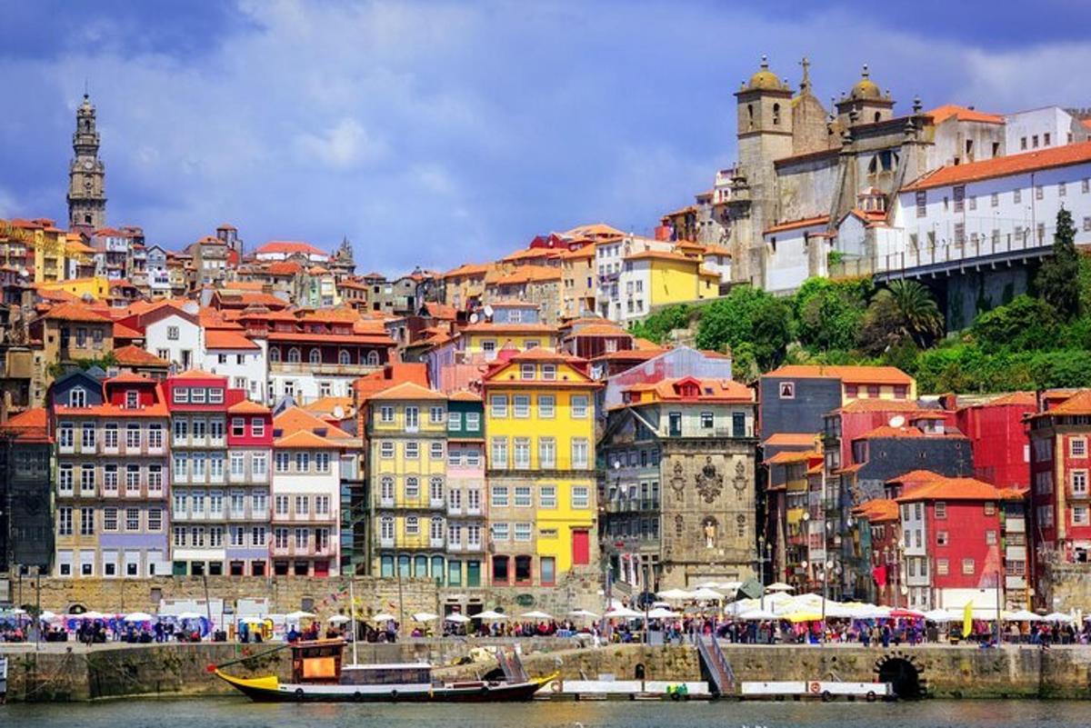 a group of colorful buildings on a hill next to the water