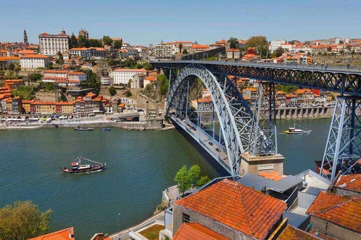 a bridge over a river with a boat in the water