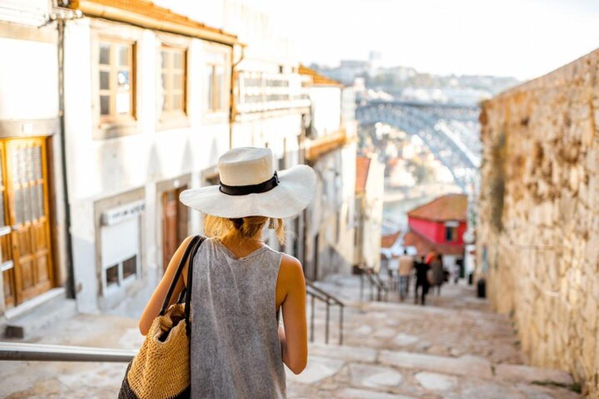 a woman wearing a hat walking down a street