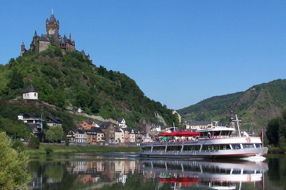 a boat on the water in front of a mountain