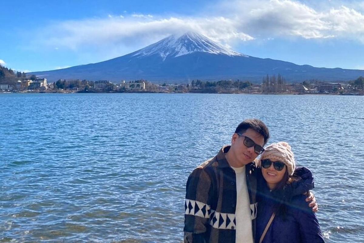 a man and a woman standing in front of a mountain